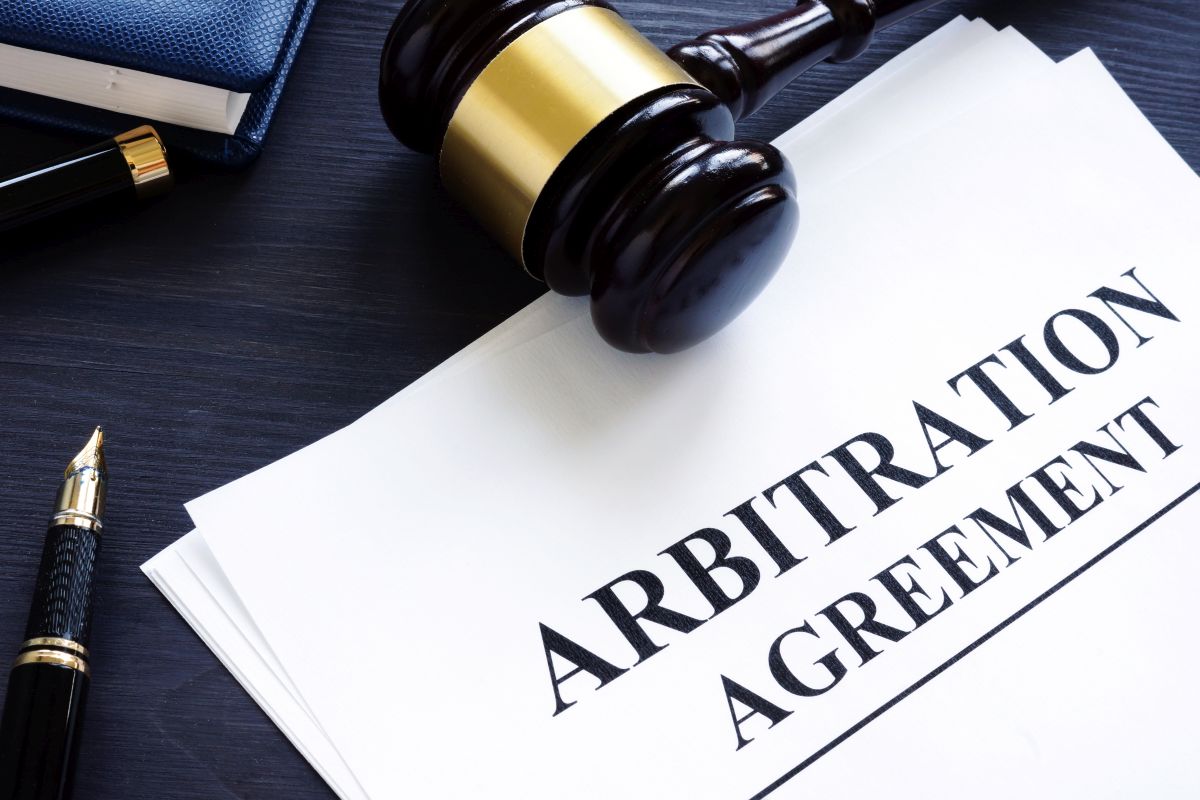 Arbitration agreement and gavel on a desk